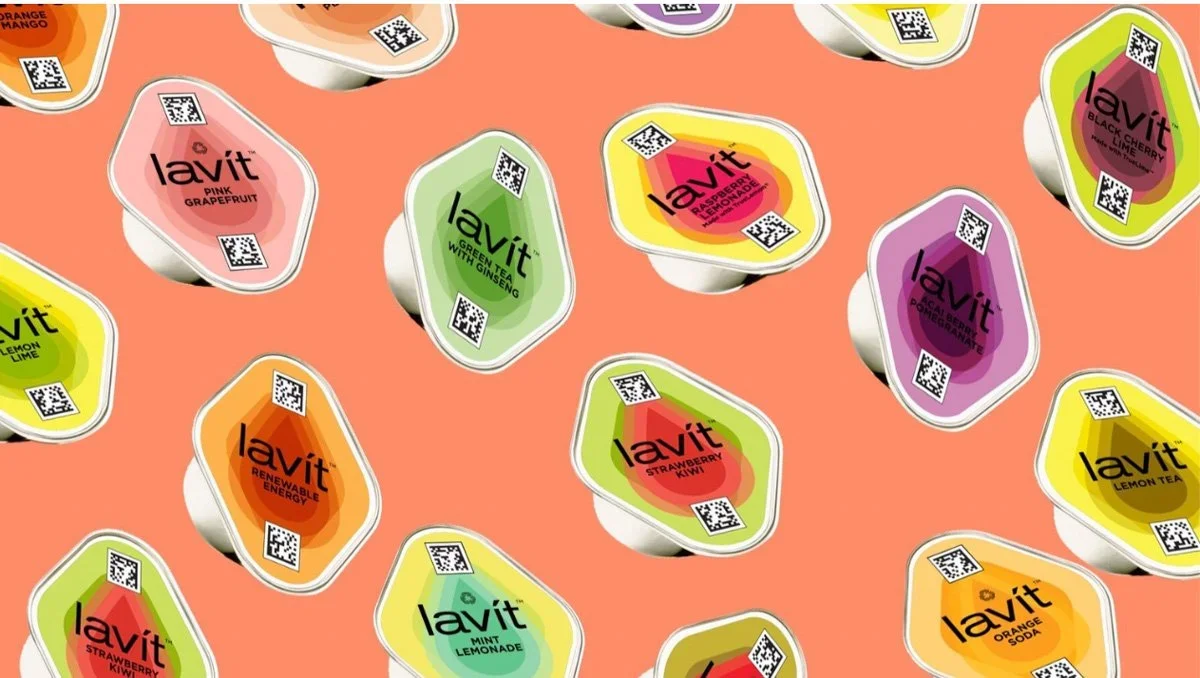 Pattern of Lavit flavored drink cups on a coral background, each with a QR code and colorful labels such as pink grapefruit, green tea with ginseng, raspberry lemon, and soy orange.